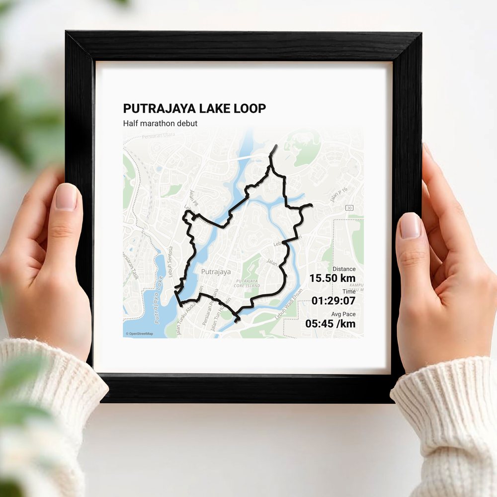 Hands holding a route print in a black frame
