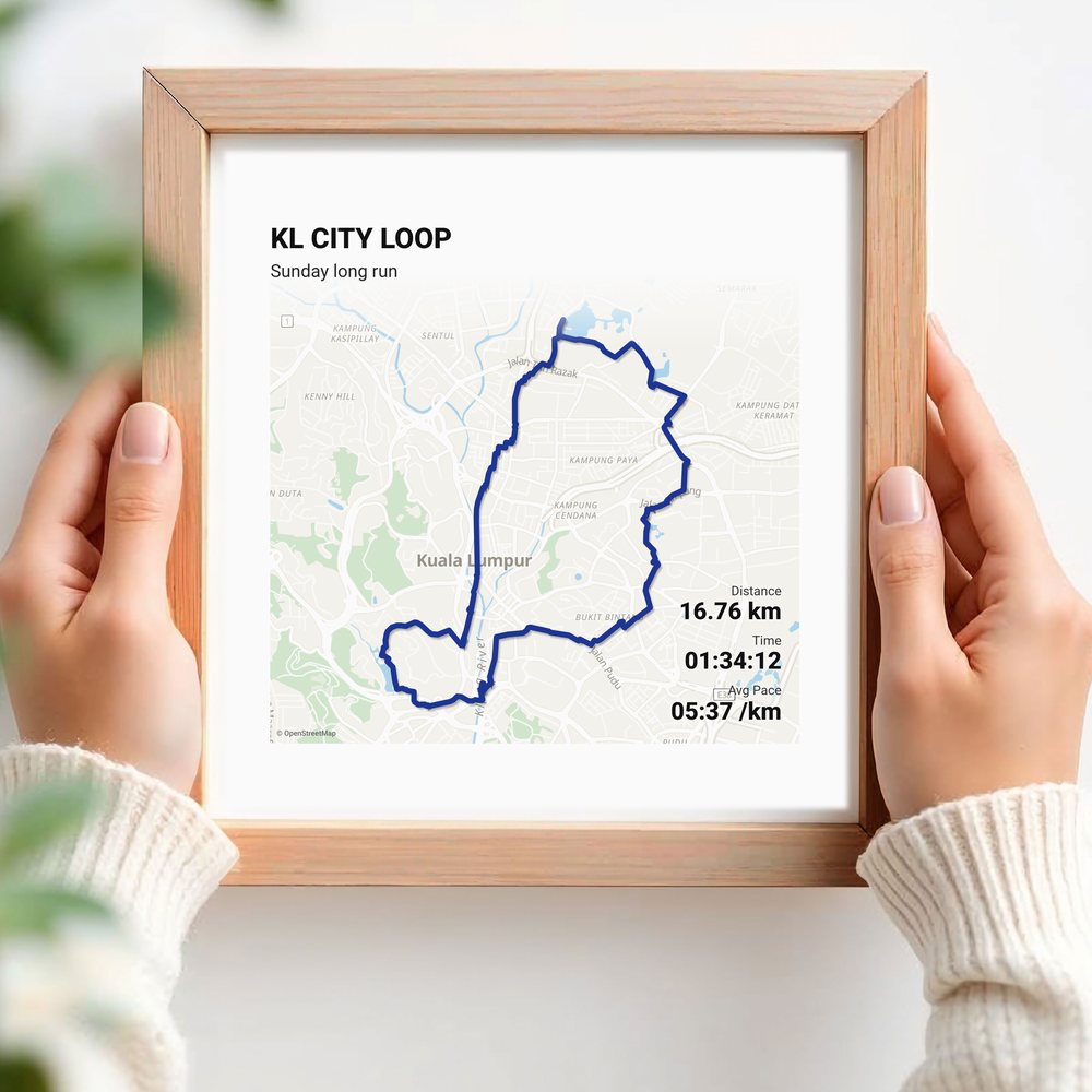 Hands holding a route print in a wood frame
